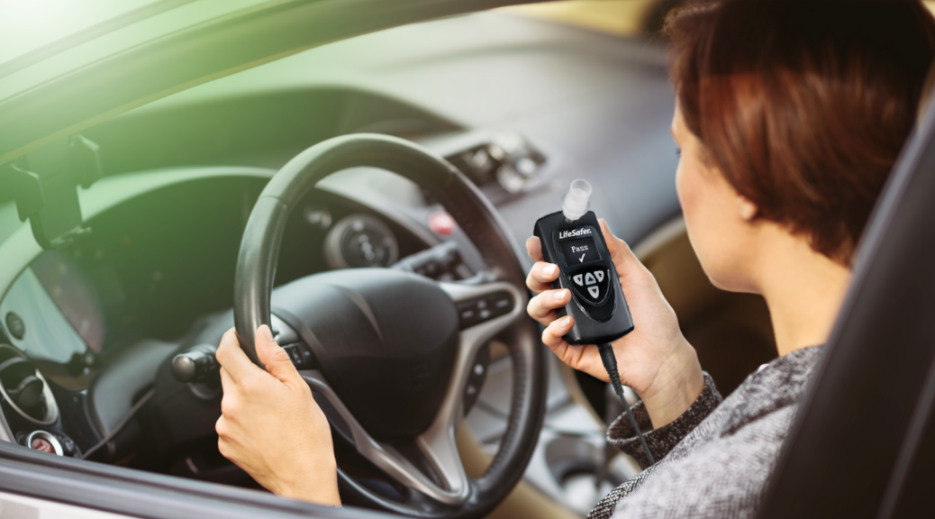 Woman about to use a LifeSafer L250 interlock device in her car