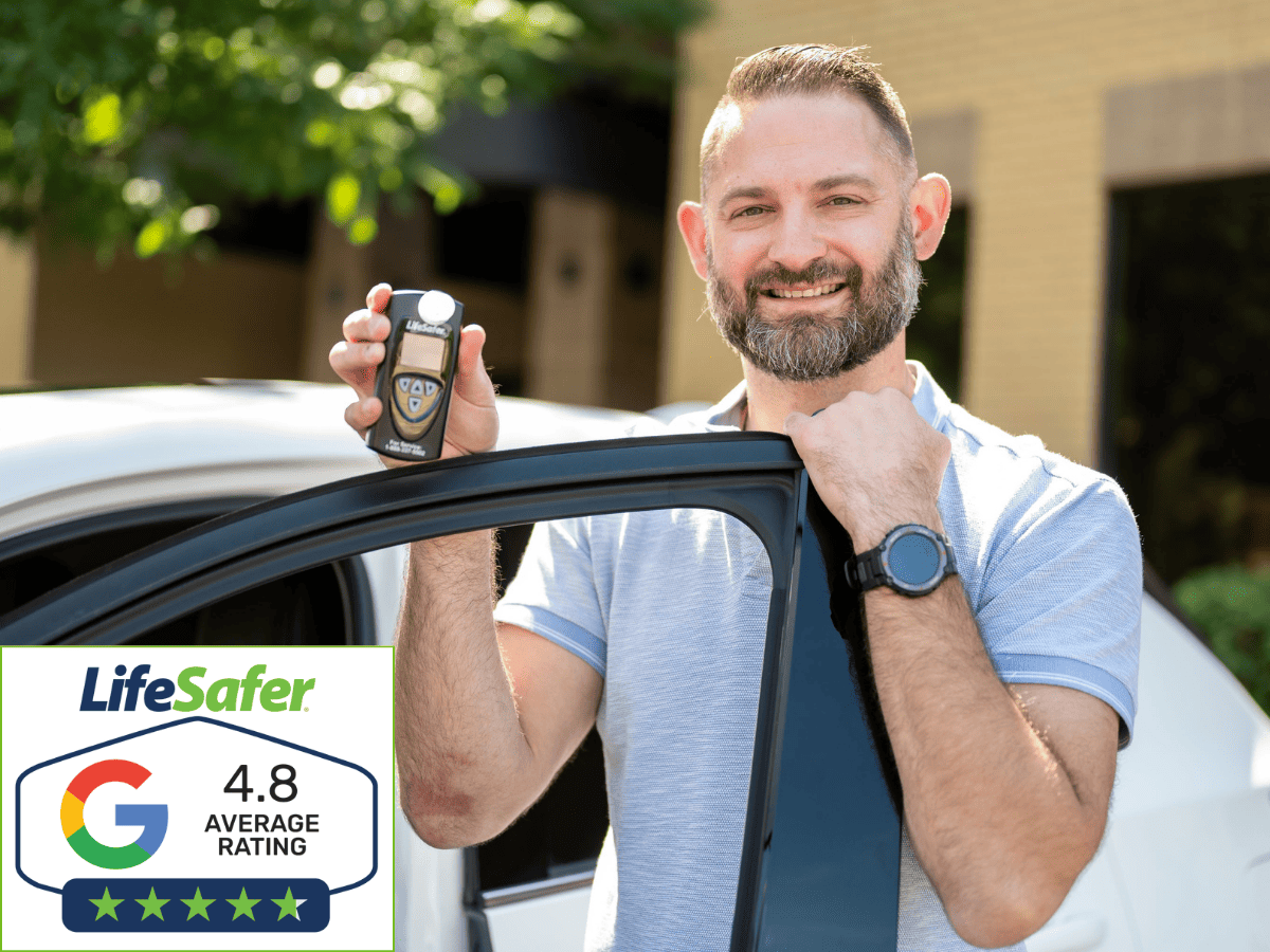 Satisfied customer standing next to their vehicle with newly installed ignition interlock device expressing happiness with the convenience of mobile service.