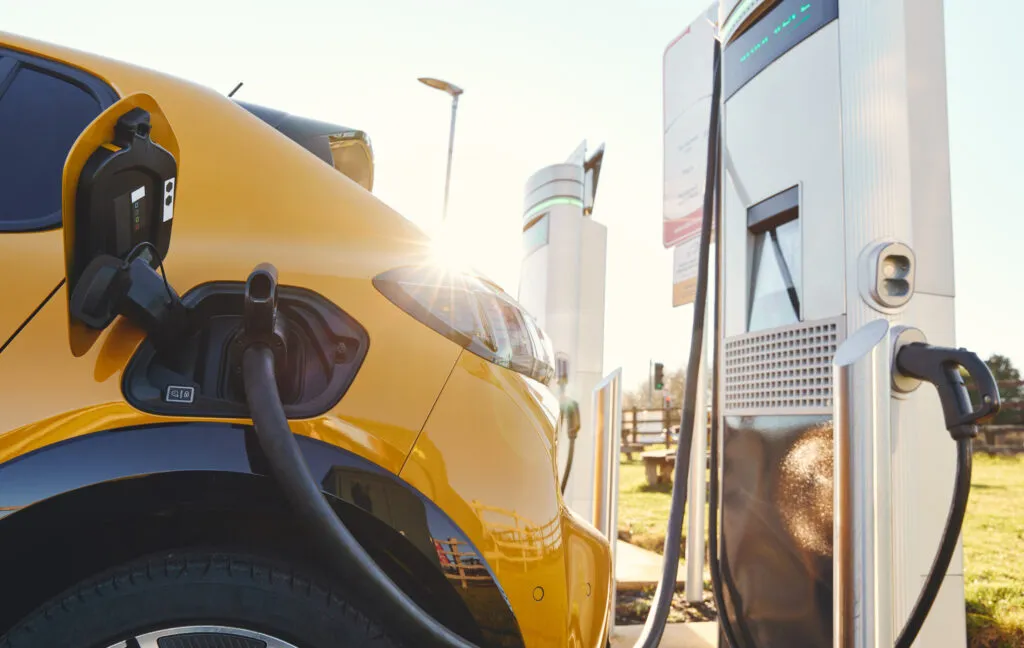 Plugged in electric car in at a EV charging station using a rapid-charger