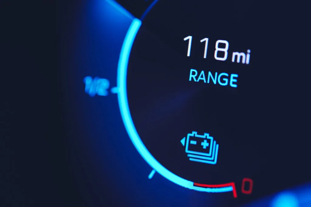 Close-in shot of electric car battery range gauge in blue